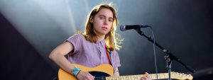Julien Baker playing guitar on stage